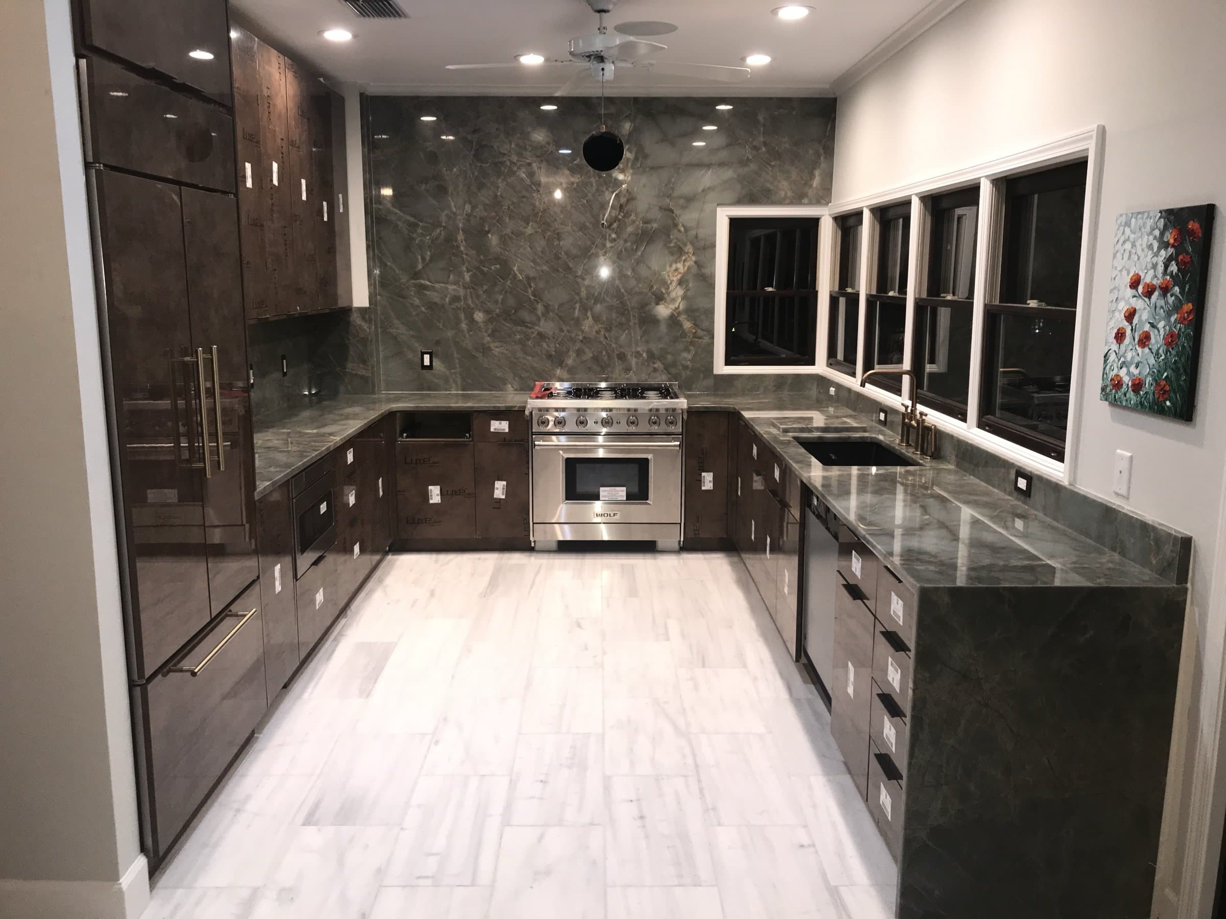 Kitchen with natural stone countertops and backsplash installed by CR Surfaces
